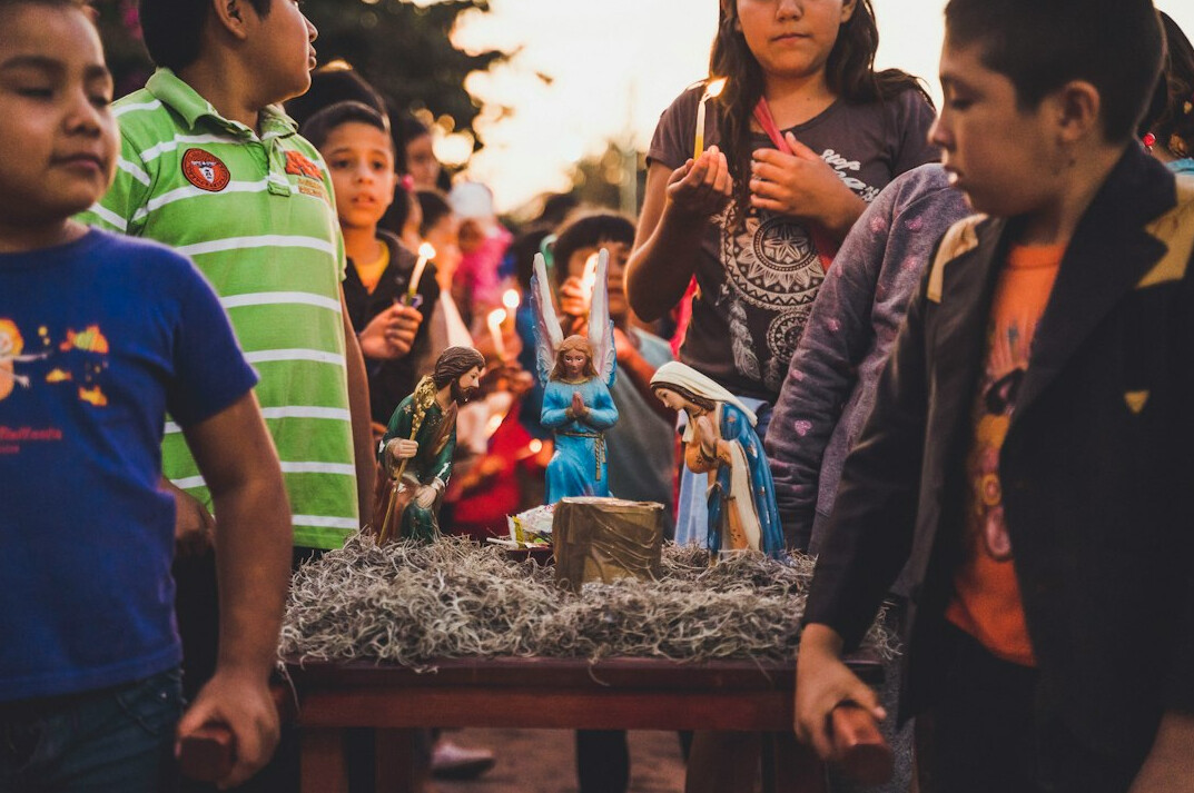 Group of young Mexican friends studying and talking together around a table