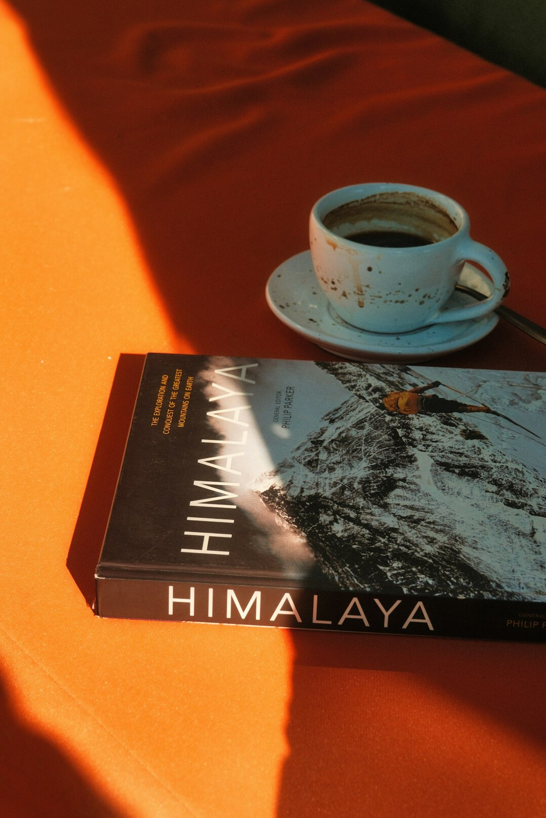 Open book and coffee cup on a wooden table