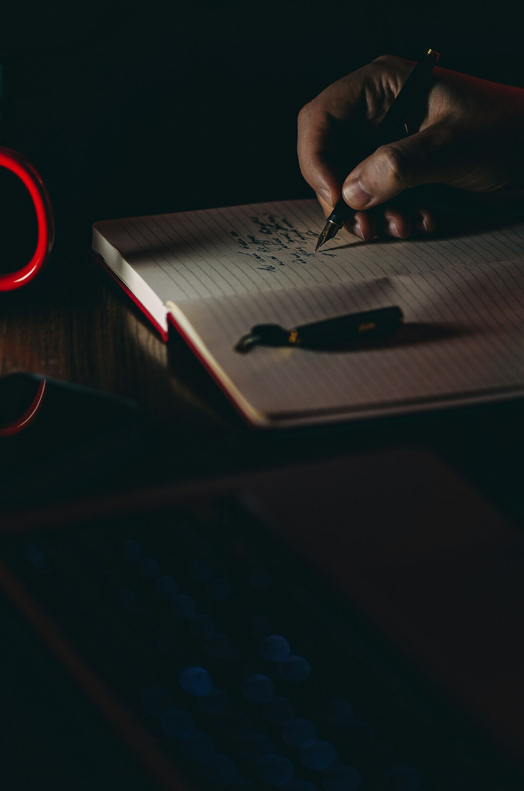 person writing in journal
